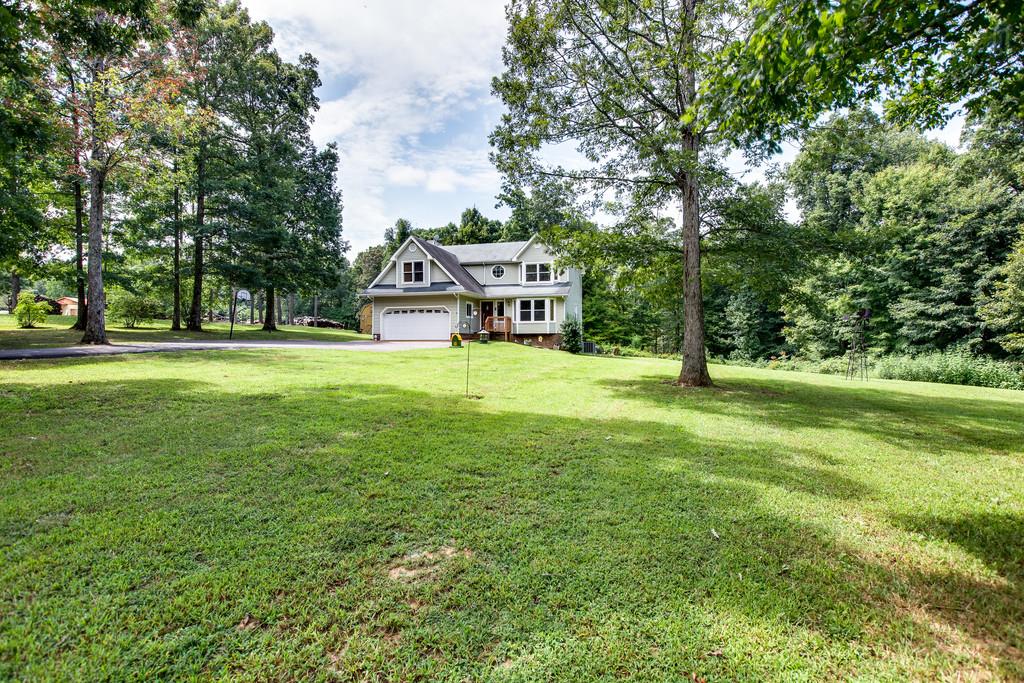 5909 Parham Road Franklin, TN 37064 - Photo 2 of 23 a view of a house with a big yard and large trees
