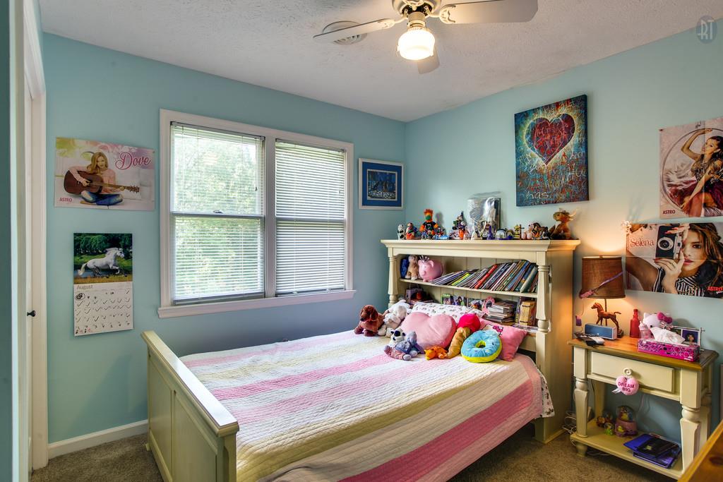 5909 Parham Road Franklin, TN 37064 - Photo 15 of 23 a bedroom with a bed and a chandelier