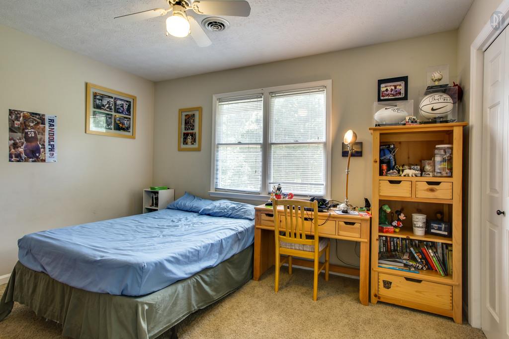 5909 Parham Road Franklin, TN 37064 - Photo 16 of 23 a bedroom with a bed and a chandelier