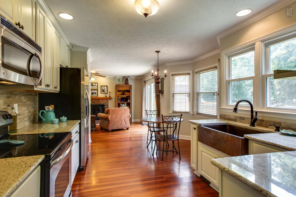 5909 Parham Road Franklin, TN 37064 - Photo 6 of 23 a kitchen with stainless steel appliances granite countertop a sink a stove and a refrigerator