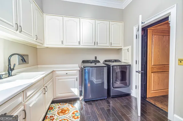 a living room with furniture floor to ceiling windows and a flat screen tv