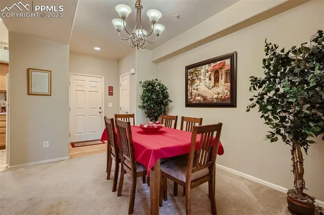 a view of a dining room with furniture and chandelier