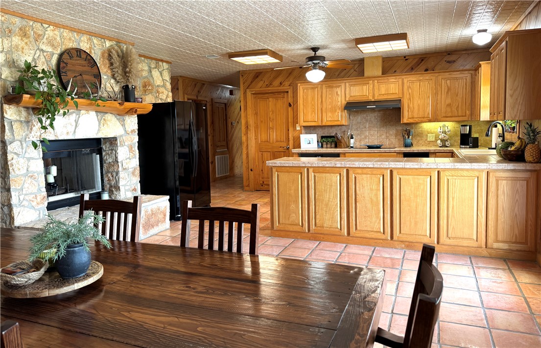 5567 County Road 1441 Mathis, TX 78368 - Photo 13 of 28 a kitchen with a table chairs and a wooden floor
