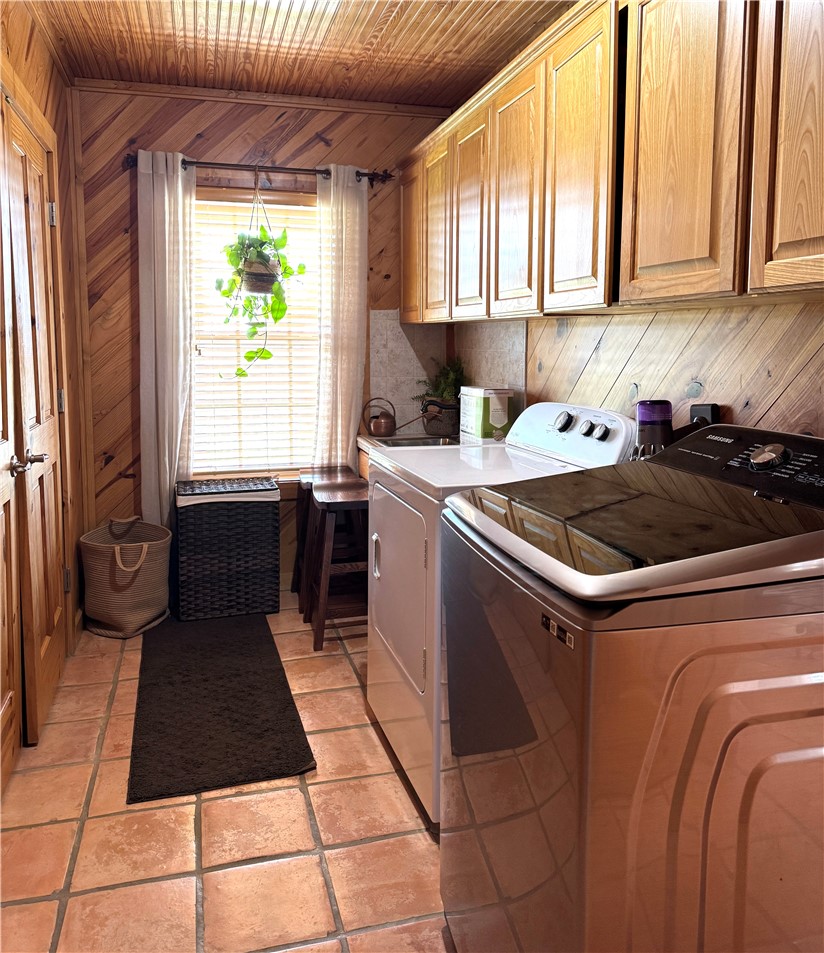 5567 County Road 1441 Mathis, TX 78368 - Photo 16 of 28 a kitchen with a sink a stove cabinets and a dining table