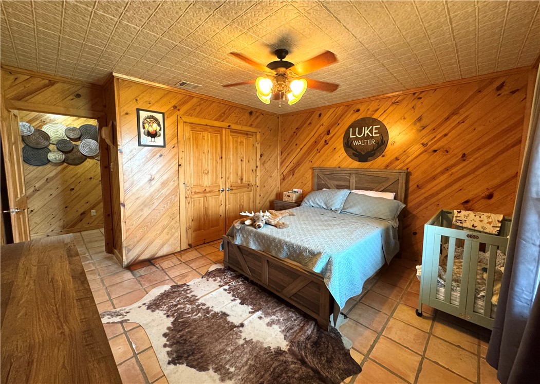 5567 County Road 1441 Mathis, TX 78368 - Photo 18 of 28 a bedroom with a bed and a painting on the wall