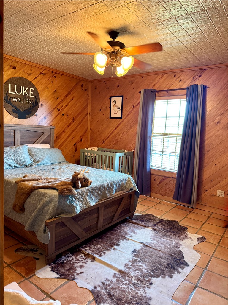5567 County Road 1441 Mathis, TX 78368 - Photo 19 of 28 a bedroom with a bed and dresser with mirror