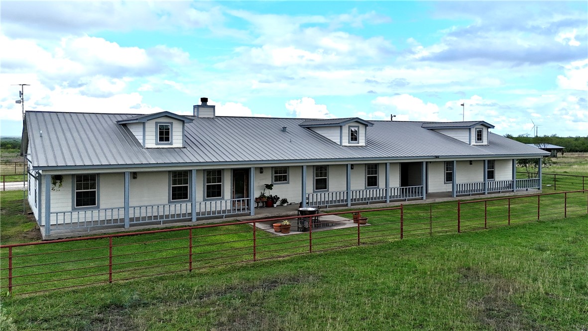 5567 County Road 1441 Mathis, TX 78368 - Photo 2 of 28 a front view of a house with a garden