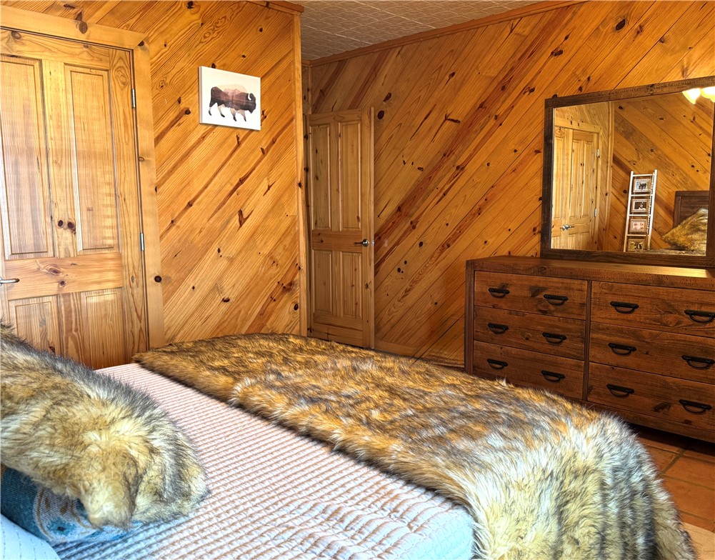 5567 County Road 1441 Mathis, TX 78368 - Photo 23 of 28 a bedroom with a bed and a painting on the wall