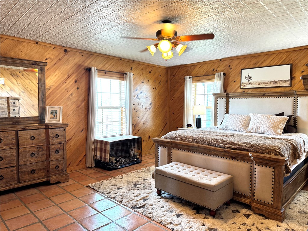 5567 County Road 1441 Mathis, TX 78368 - Photo 24 of 28 a bedroom with a bed and a chandelier