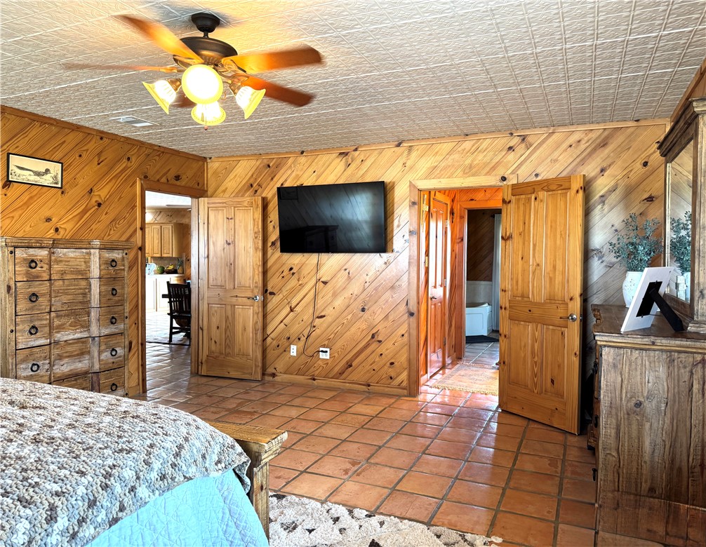 5567 County Road 1441 Mathis, TX 78368 - Photo 25 of 28 a bedroom with a bed and a television