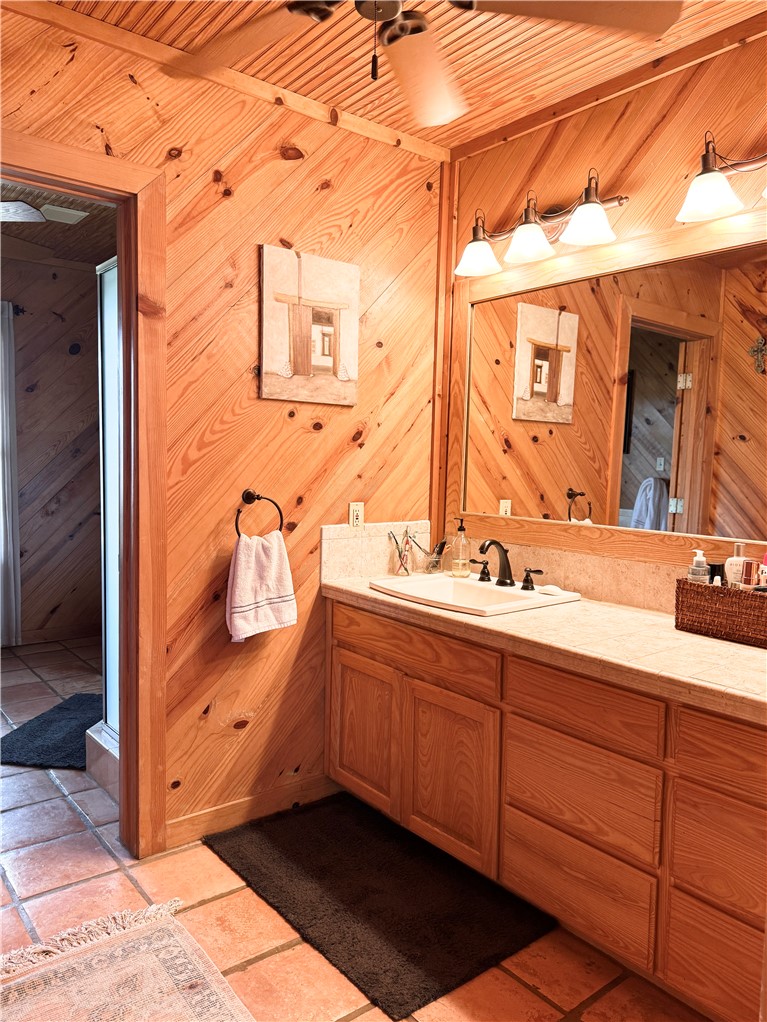5567 County Road 1441 Mathis, TX 78368 - Photo 26 of 28 a bathroom with a sink double vanity and a mirror