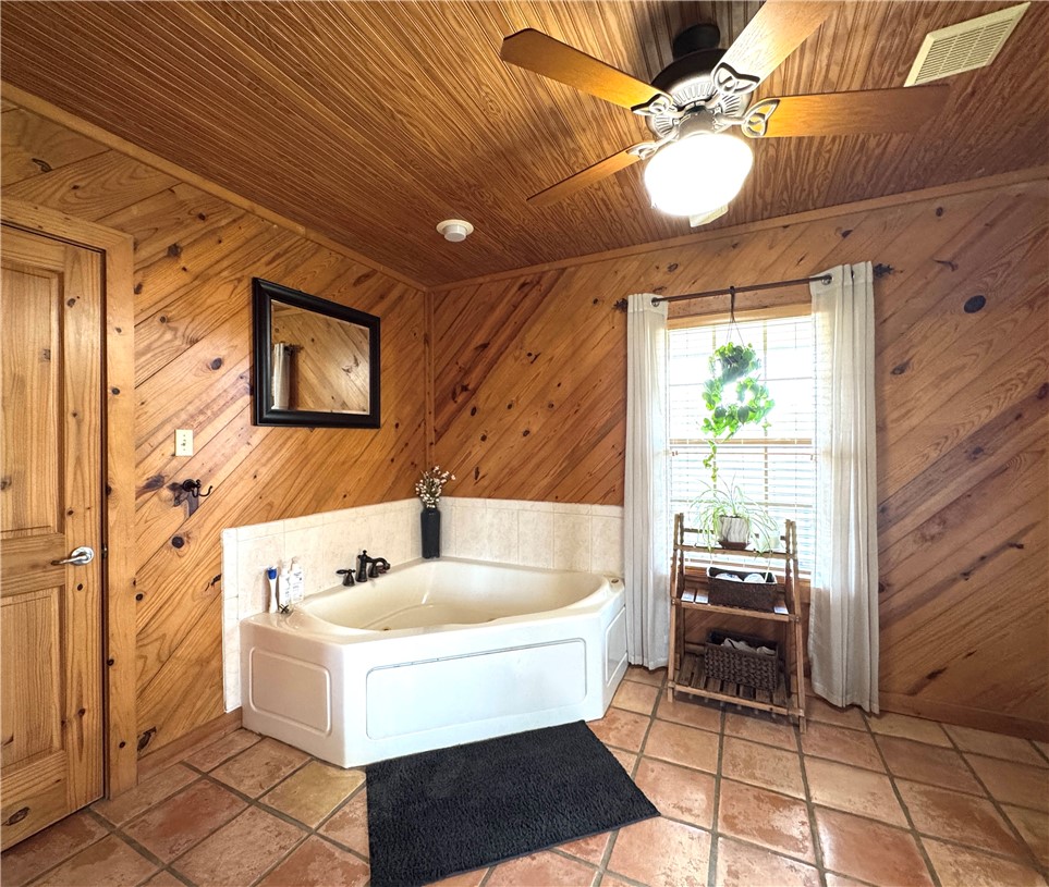 5567 County Road 1441 Mathis, TX 78368 - Photo 28 of 28 a white bath tub sitting in a bathroom next to a window