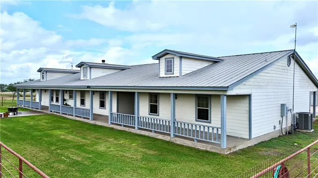a view of a house with a yard and deck