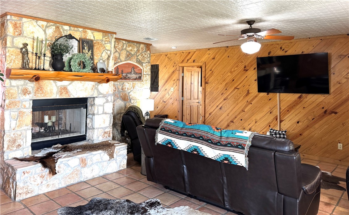 5567 County Road 1441 Mathis, TX 78368 - Photo 5 of 28 a living room with furniture a fireplace and a flat screen tv