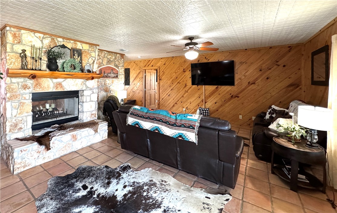 5567 County Road 1441 Mathis, TX 78368 - Photo 6 of 28 a living room with furniture a flat screen tv and a fireplace