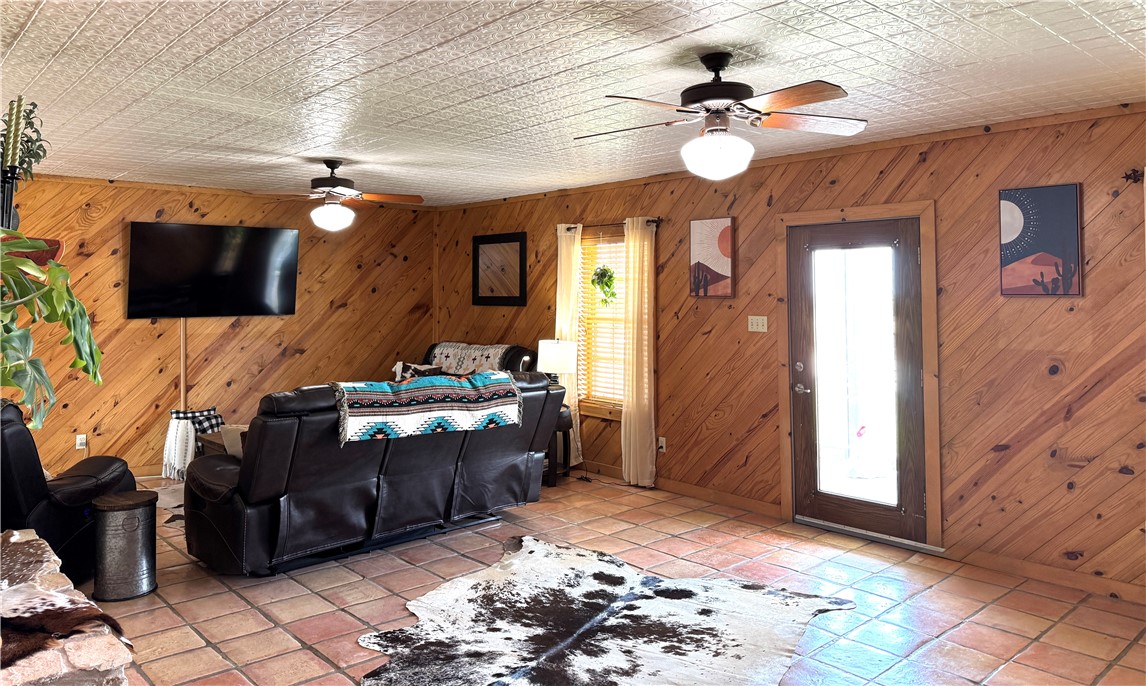 5567 County Road 1441 Mathis, TX 78368 - Photo 7 of 28 a living room with furniture and a flat screen tv