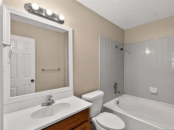 a bathroom with a sink toilet tub and shower