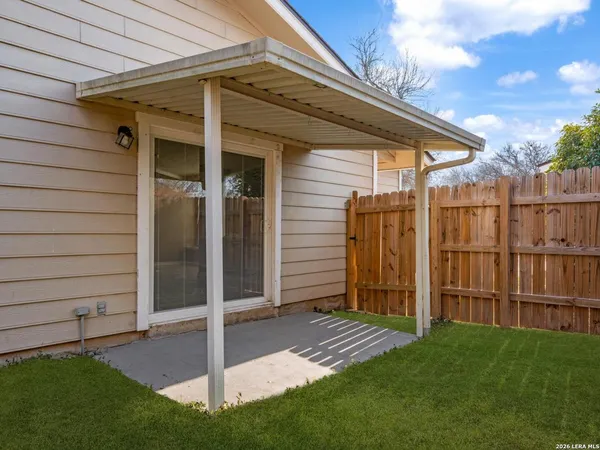 a view of a backyard with wooden fence