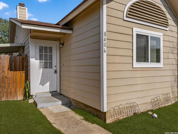 a view of front door and small yard