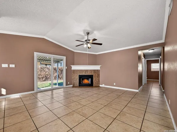 a view of a livingroom with a fireplace and window