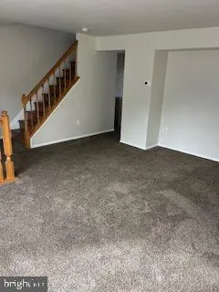 a view of an empty room with stairs