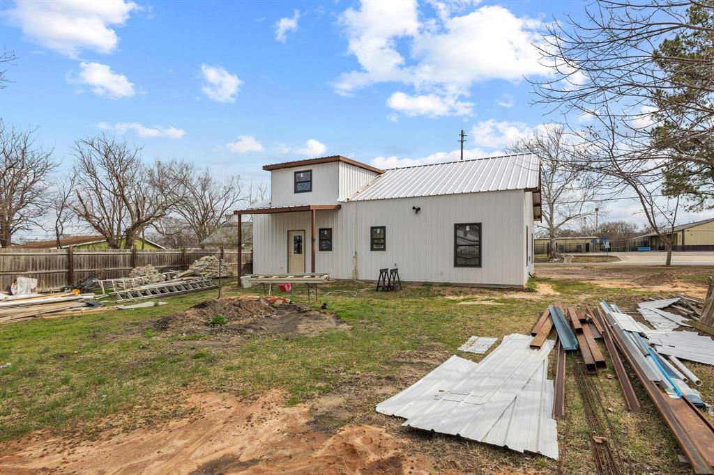 204 South Main Street Ector, TX 75439 - Photo 5 of 18 a view of a house with a yard