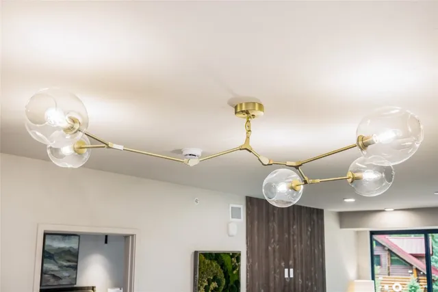 a view of a chandelier fan and wooden floor