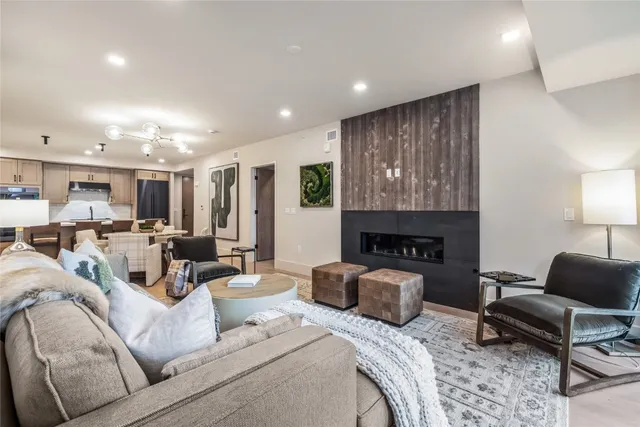 a living room with furniture a fireplace and a lamp