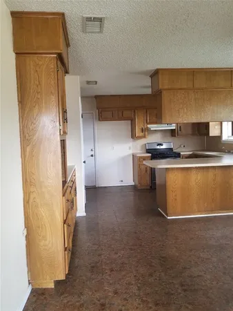 a kitchen with stainless steel appliances granite countertop a refrigerator and a stove