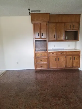 a kitchen with granite countertop a sink and a stove
