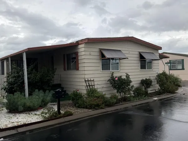 a front view of a house with garden