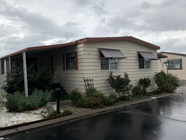 a front view of a house with lake