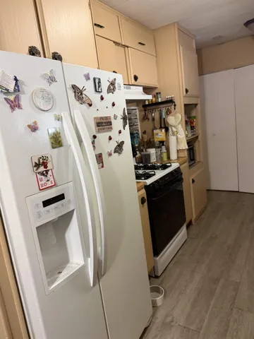 a stove top oven sitting inside of a kitchen