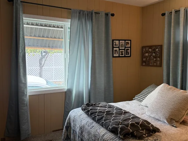 a bedroom with a bed and chair