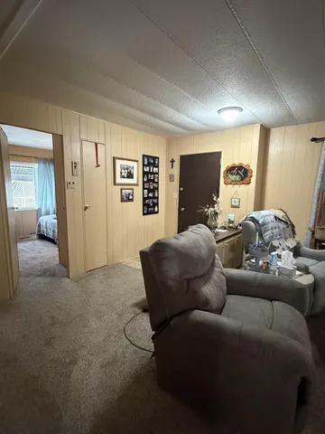 a view of a livingroom with furniture and a flat screen tv