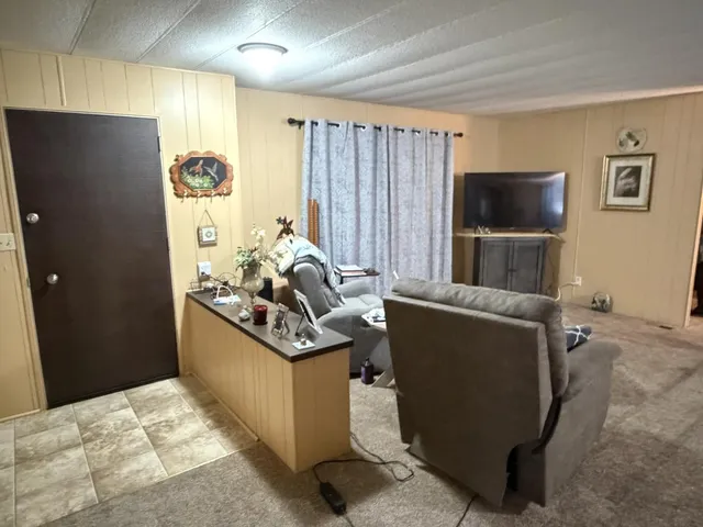 a view of a livingroom with furniture and a window
