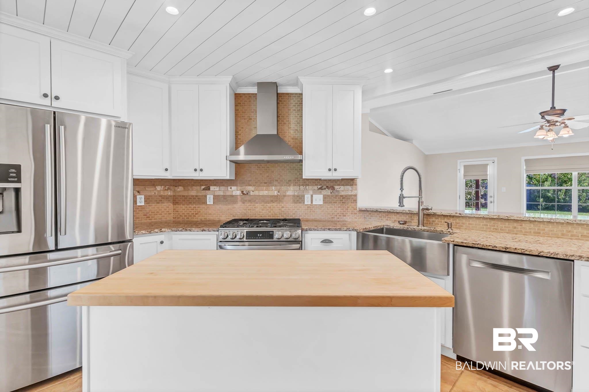 9607 Czar Court Fairhope, AL 36532 - Photo 13 of 42 Kitchen with stainless steel appliances, wooden counters, tasteful backsplash, recessed lighting, and wall chimney range hood