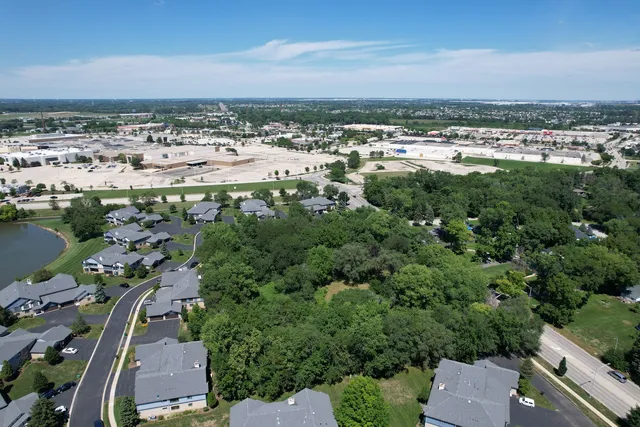 an aerial view of residential house with outdoor space and trees all around