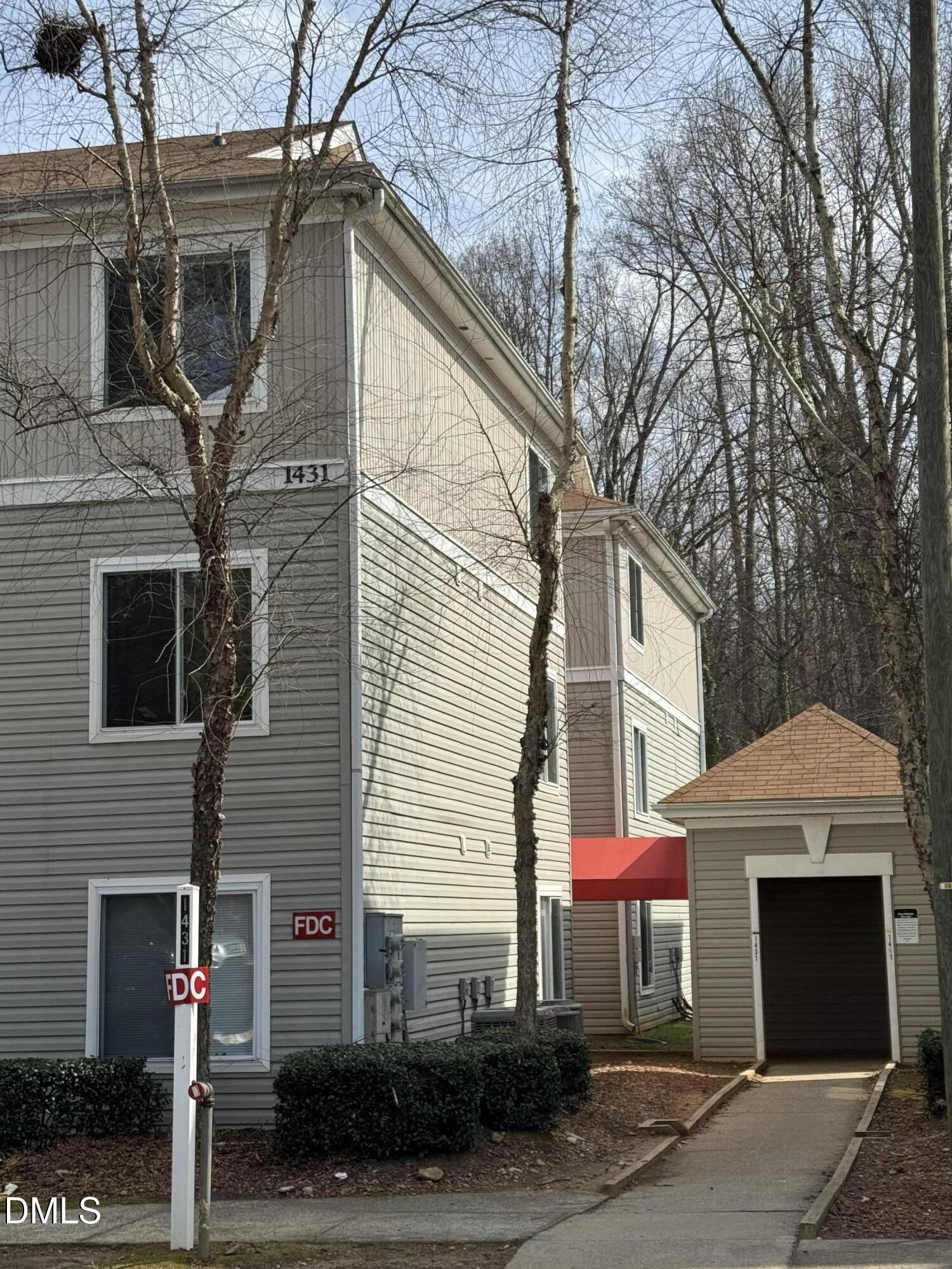 1431 Collegiate Circle, Unit 101 Raleigh, NC 27606 - Photo 2 of 11 a view of a white house with large windows