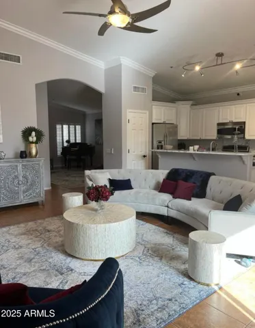 a living room with furniture and kitchen view