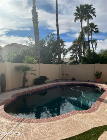 a view of a swimming pool with a yard