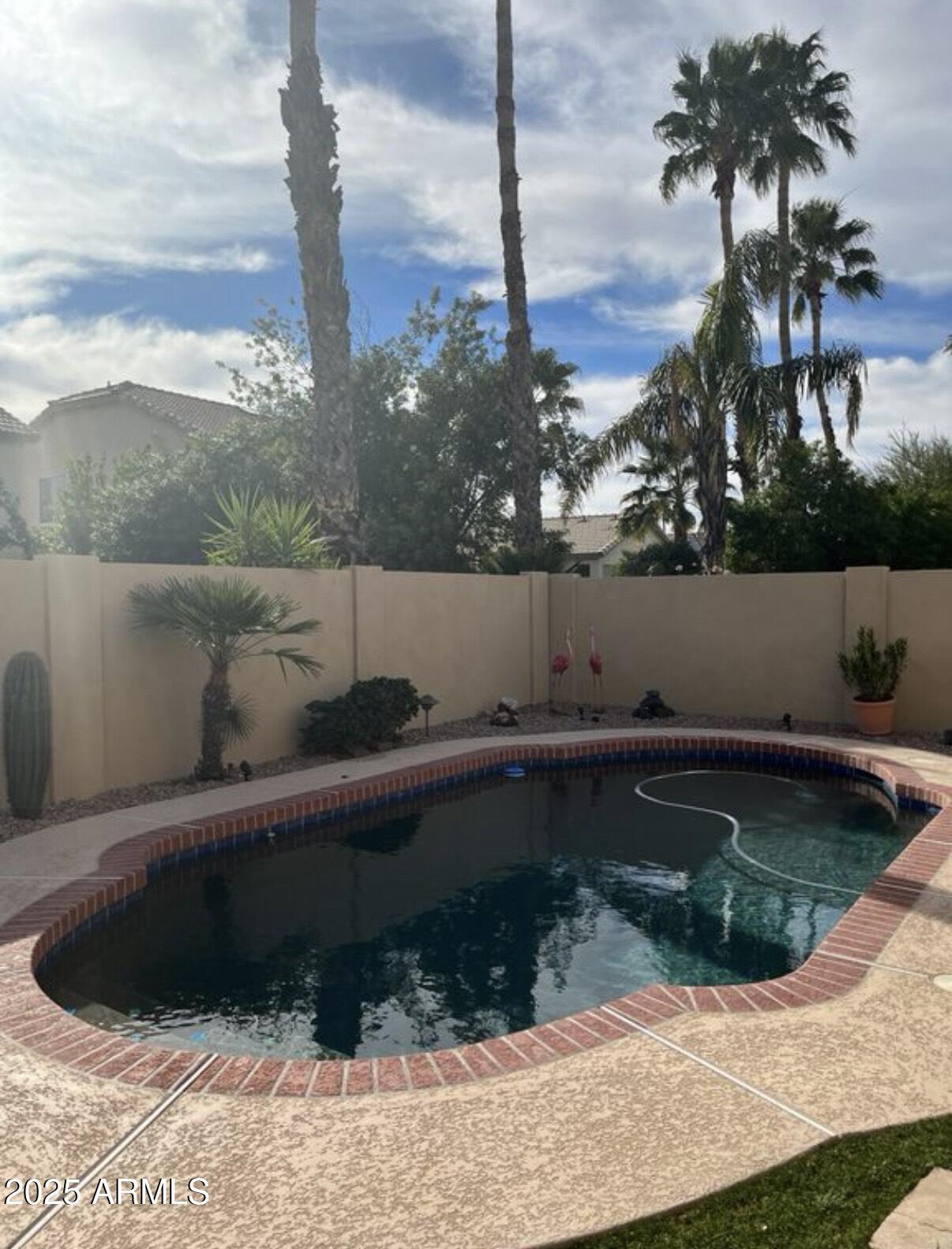 9233 East Blanche Drive Scottsdale, AZ 85260 - Photo 4 of 13 a view of a swimming pool with a yard