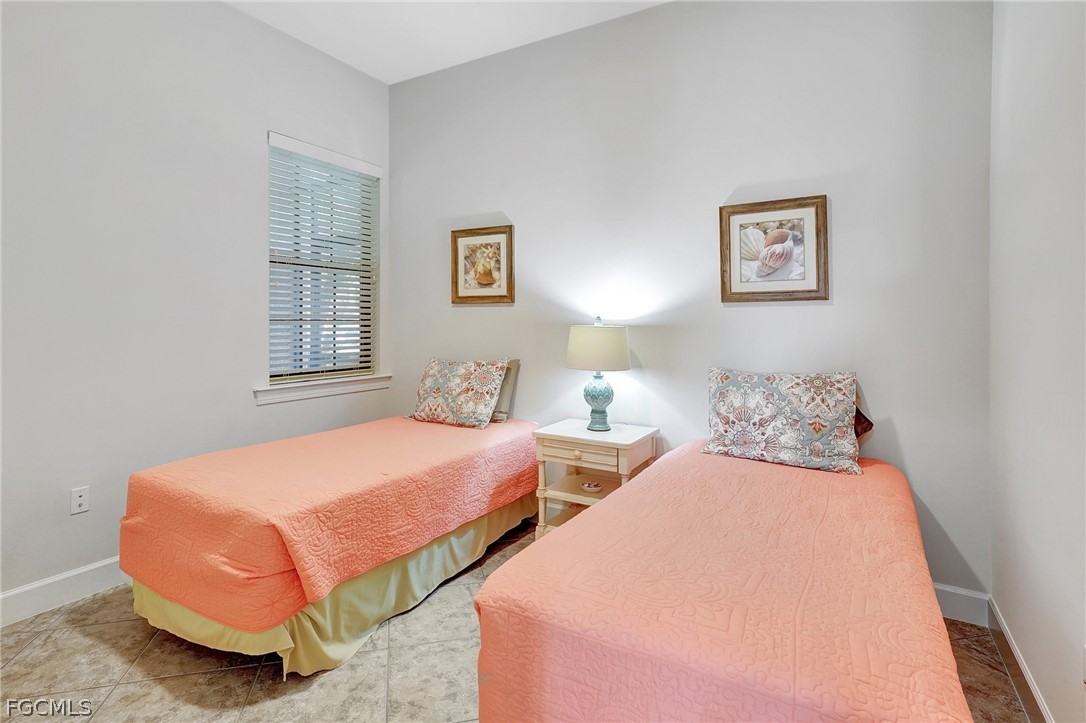 10879 Rutherford Road Fort Myers, FL 33913 - Photo 16 of 36 a bedroom with two beds and painting on the wall