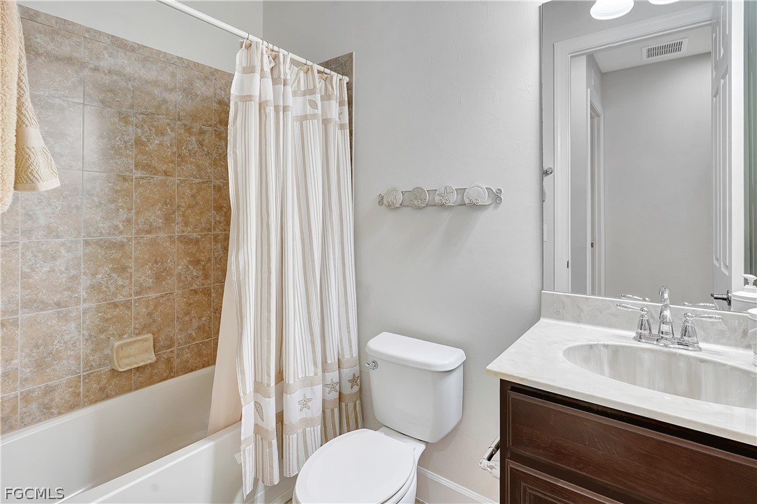 10879 Rutherford Road Fort Myers, FL 33913 - Photo 18 of 36 a bathroom with a sink toilet and shower