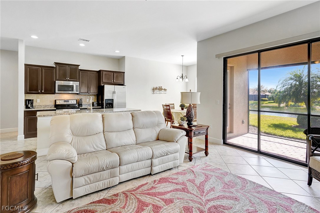 10879 Rutherford Road Fort Myers, FL 33913 - Photo 4 of 36 a living room with furniture and a large window