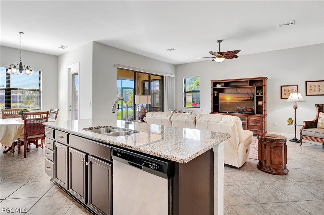 10879 Rutherford Road Fort Myers, FL 33913 - Photo 8 of 36 a kitchen with granite countertop a sink and a refrigerator