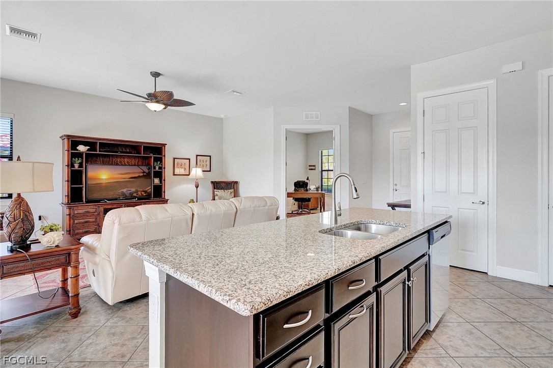 10879 Rutherford Road Fort Myers, FL 33913 - Photo 9 of 36 a kitchen island with granite countertop a table and chairs