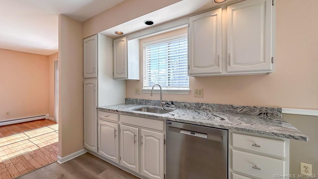 8 Derby Court, Unit 8 Brookfield, CT 06804 - Photo 11 of 26 a kitchen with granite countertop white cabinets and a window