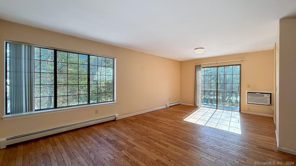 8 Derby Court, Unit 8 Brookfield, CT 06804 - Photo 14 of 26 a view of an empty room with wooden floor and a window