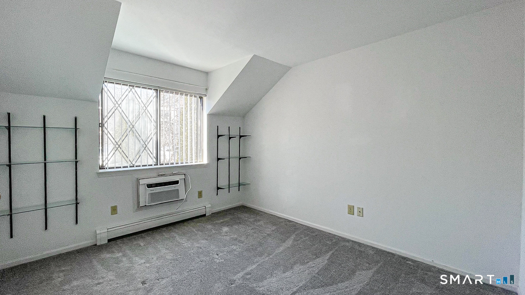 8 Derby Court, Unit 8 Brookfield, CT 06804 - Photo 22 of 26 a view of an empty room with a window and kitchen